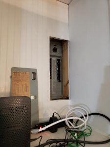 A room with electrical equipment and wires in it.